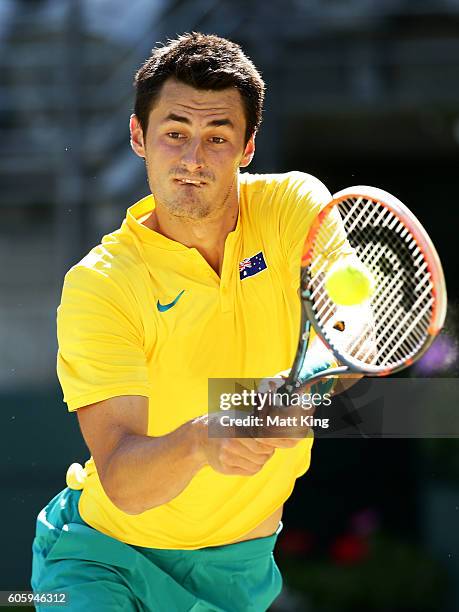 Bernard Tomic of Australia plays a backhand in his singles match against Jozef Kovalik of Slovakia during the Davis Cup World Group playoff between...