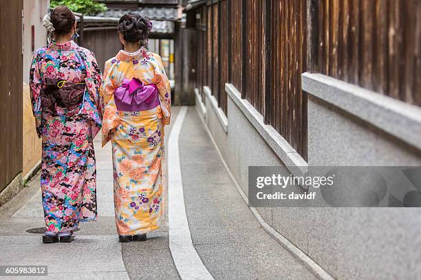 kimono wearing traditional young japanese women walking in gion kyoto - yukata bildbanksfoton och bilder