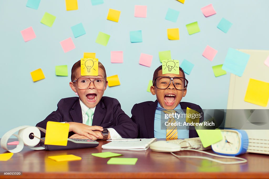 Two Young Businessmen Covered with Light Bulb Sticky Notes