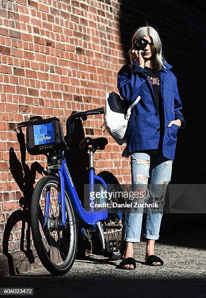 Samantha Angelo is seen wearing the Bill Cunningham inspired blue jacket by NYFW x Villency Design Group on the streets of Soho during New York...