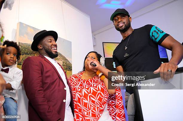 Bob Metelus, Lisa Metelus and Dwyane Wade attend Haitian photographer Bob Metelus unveils newest collection, Haiti: A Collective Cry from a Forgotten...