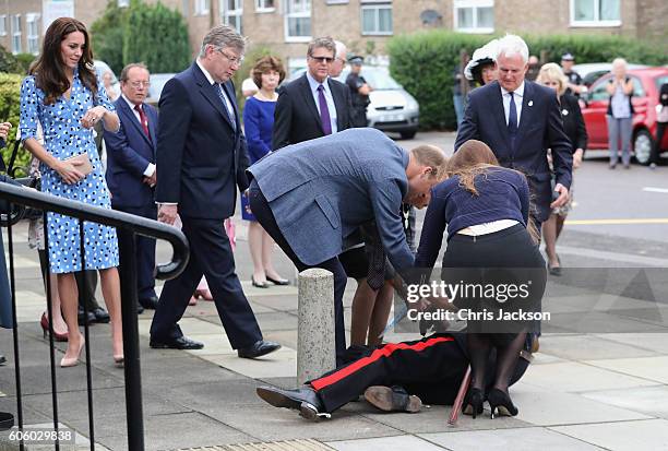 Catherine, Duchess of Cambridge looks on as Prince William, Duke of Cambridge rushes to helpVice Lord Lieutenant of Essex Jonathon Douglas-Hughes who...