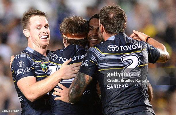 Justin O'Neill of the Cowboys is congratulated by team mates after scoring a try during the first NRL semi final between North Queensland Cowboys and...
