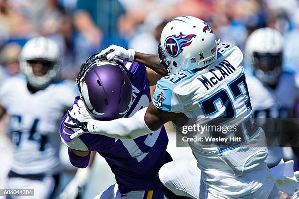 Brice McCain of the Tennessee Titans tackles Adam Thielen of the Minnesota Vikings after catching a pass at Nissan Stadium on September 11, 2016 in...