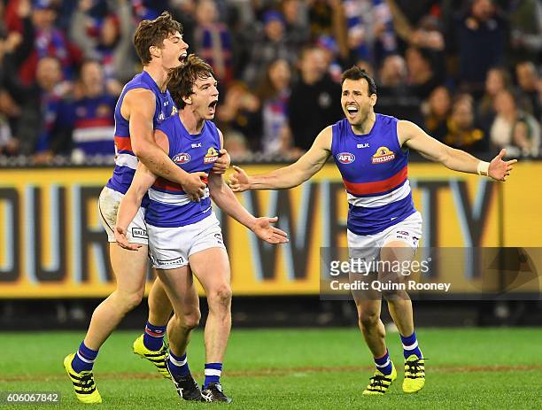 Liam Picken of the Bulldogs is congratulated by Josh Dunkley and Tory Dickson of the Bulldogs after kicking a goal during the second AFL semi final...