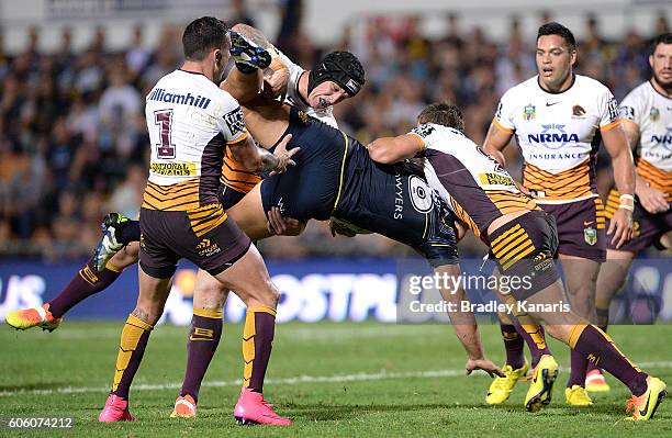 Scott Bolton of the Cowboys is picked up in the tackle by Jarrod Wallace of the Broncos during the first NRL semi final between North Queensland...