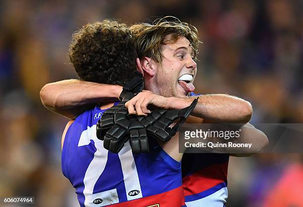 Tom Liberatore and Caleb Daniel of the Bulldogs celebrate winning the second AFL semi final between Hawthorn Hawks and Western Bulldogs at Melbourne...