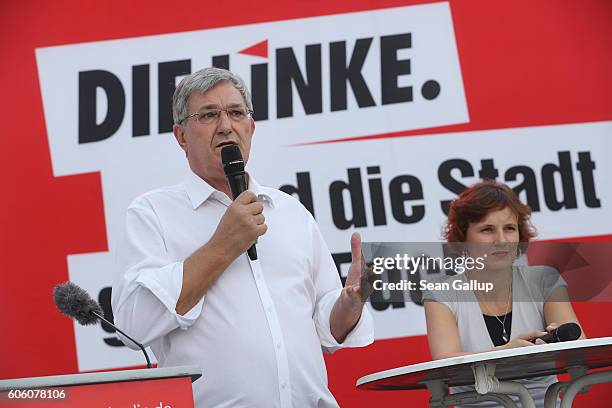 Bernd Riexinger and Katja Kipping, leading members of the left-wing Die Linke political party, speak to supporters at an election campaign rally...