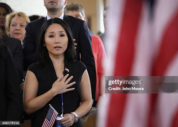 South Korean immigrant and CNN reporter MJ Lee recites the Pledge of Allegiance during a naturalization ceremony in the Great Hall of Ellis Island on...