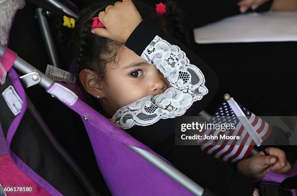 Immigrant families take part in a naturalization ceremony on Ellis Island on September 16, 2016 in New York City. The ceremony marked U.S....
