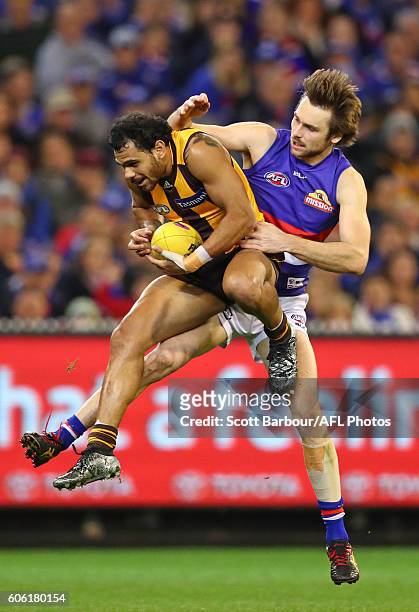 Cyril Rioli of the Hawks marks the ball against Joel Hamling of the Bulldogs and kicks a goal during the second AFL semi final between Hawthorn Hawks...
