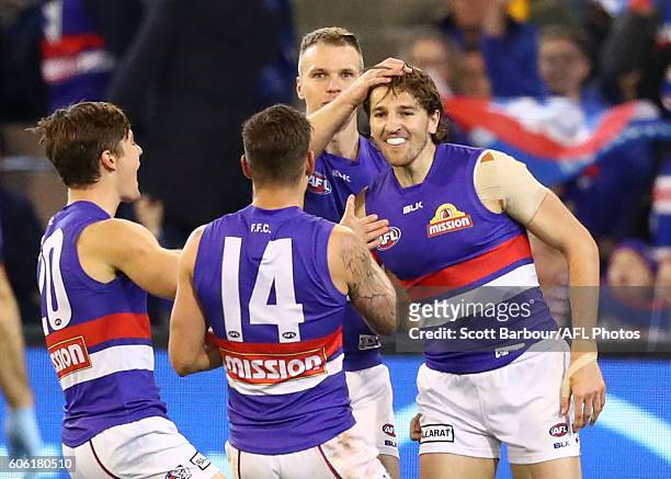 Marcus Bontempelli of the Bulldogs is congratulated by his teammates after kicking a goal during the second AFL semi final between Hawthorn Hawks and...