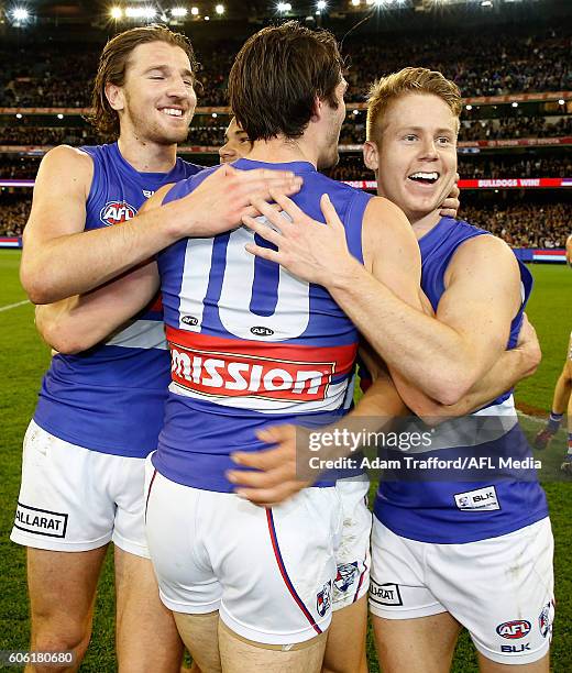 Easton Wood of the Bulldogs hugs Marcus Bontempelli and Lachie Hunter of the Bulldogs during the 2016 AFL Second Semi Final match between the...