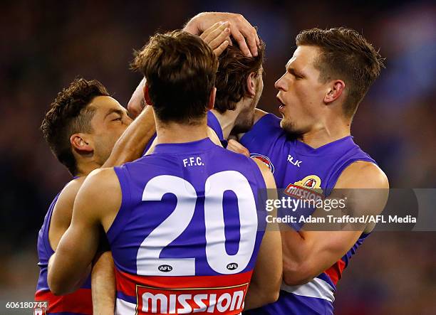 Clay Smith of the Bulldogs congratulates Marcus Bontempelli of the Bulldogs on a goal during the 2016 AFL Second Semi Final match between the...