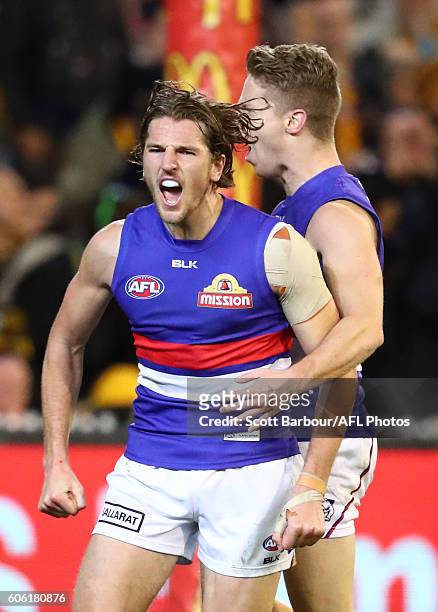 Marcus Bontempelli of the Bulldogs celebrates after kicking a goal with Lachie Hunter of the Bulldogs during the second AFL semi final between...