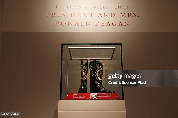 Pair of Ronald Reagan's cowboy boots sit in a case at Christie's where items from the former president and Nancy Reagan's California home are to be...