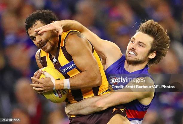 Cyril Rioli of the Hawks marks the ball against Joel Hamling of the Bulldogs and kicks a goal during the second AFL semi final between Hawthorn Hawks...