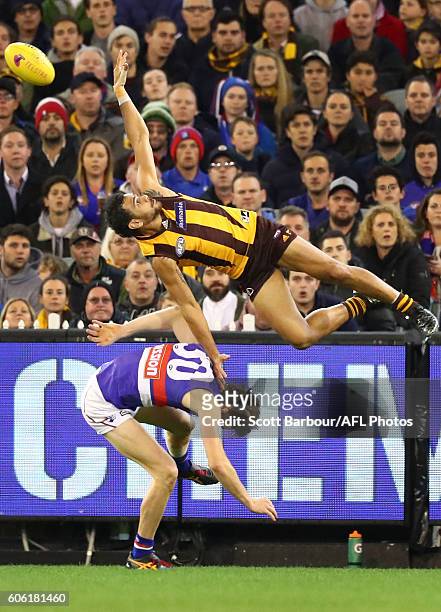 Cyril Rioli of the Hawks attempts to take a spectacular mark over Joel Hamling of the Bulldogs during the second AFL semi final between Hawthorn...