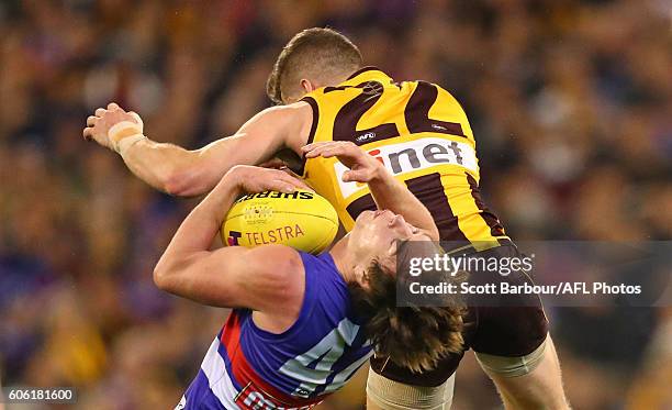 Liam Picken of the Bulldogs and Luke Breust of the Hawks smash into each other in a big collision during the second AFL semi final between Hawthorn...