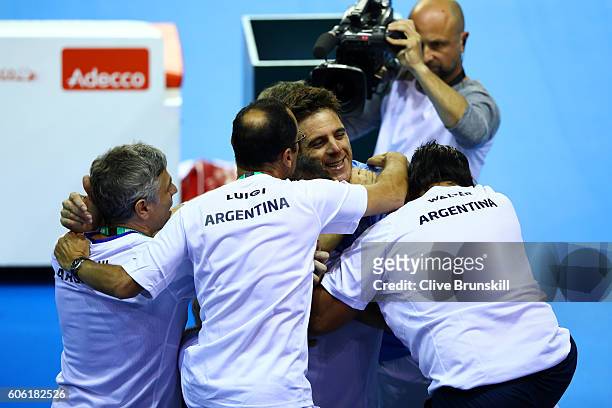 Juan Martin del Potro of Argentina celebrates victory with his team after his singles match against Andy Murray of Great Britain during day one of...