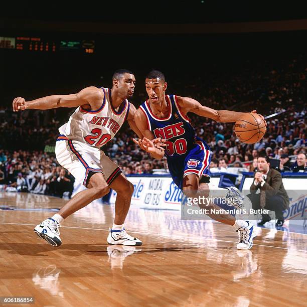 Kerry Kittles of the New Jersey Nets drives to the basket while guarded by Allan Houston of the New York Knicks at Madison Square Garden in New York,...