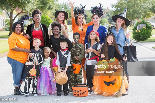 group of women with children in halloween costumes - princess pirates stock pictures, royalty-free photos & images