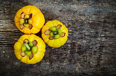 Garcinia cambogia fresh fruit on wood background.