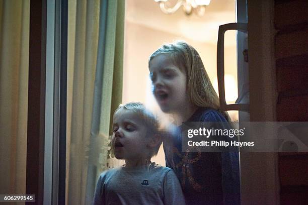 children breathing on cold window - breath vapor stock pictures, royalty-free photos & images