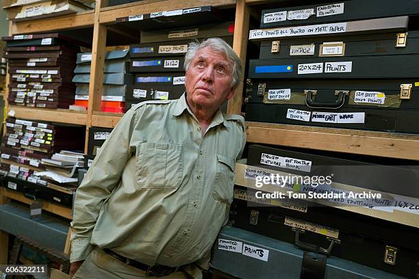 British war photographer Don McCullin with boxes of his photographs stored in the print room at his home in Somerset, 21st July 2015.