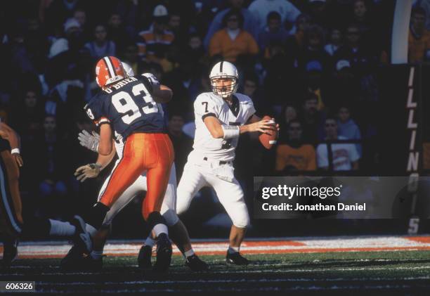 Quarterback Zack Mills of the Pennsylvania State Nittany Lions running with the ball away from Defensive End Mike O''Brien during the game against...