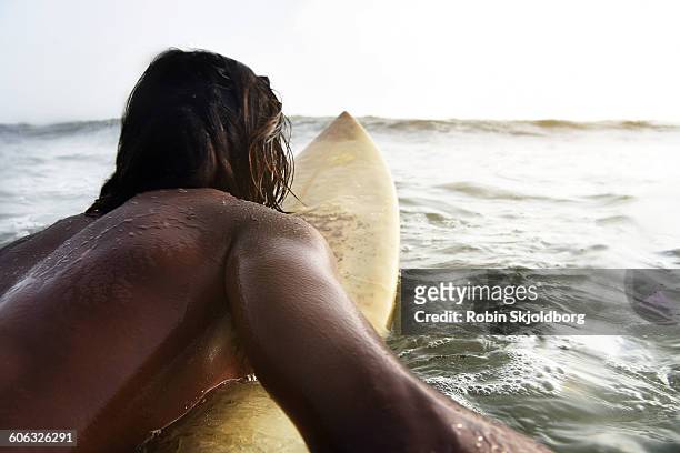 surfer paddling out toward wave - using a paddle stock pictures, royalty-free photos & images