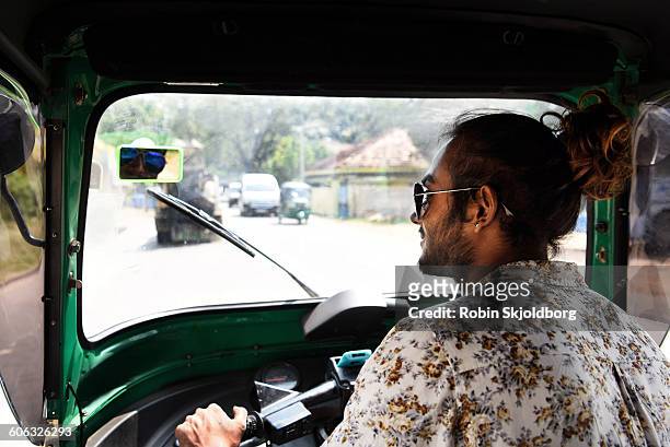 young sri lankan man driving tuk tuk - aviator glasses stock pictures, royalty-free photos & images