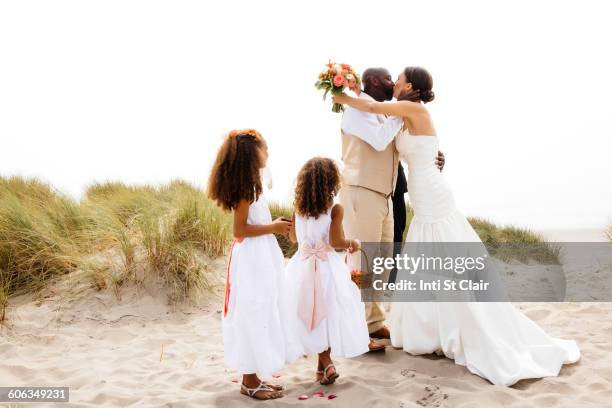 bride and groom kissing in outdoor wedding - kiss sisters foto e immagini stock