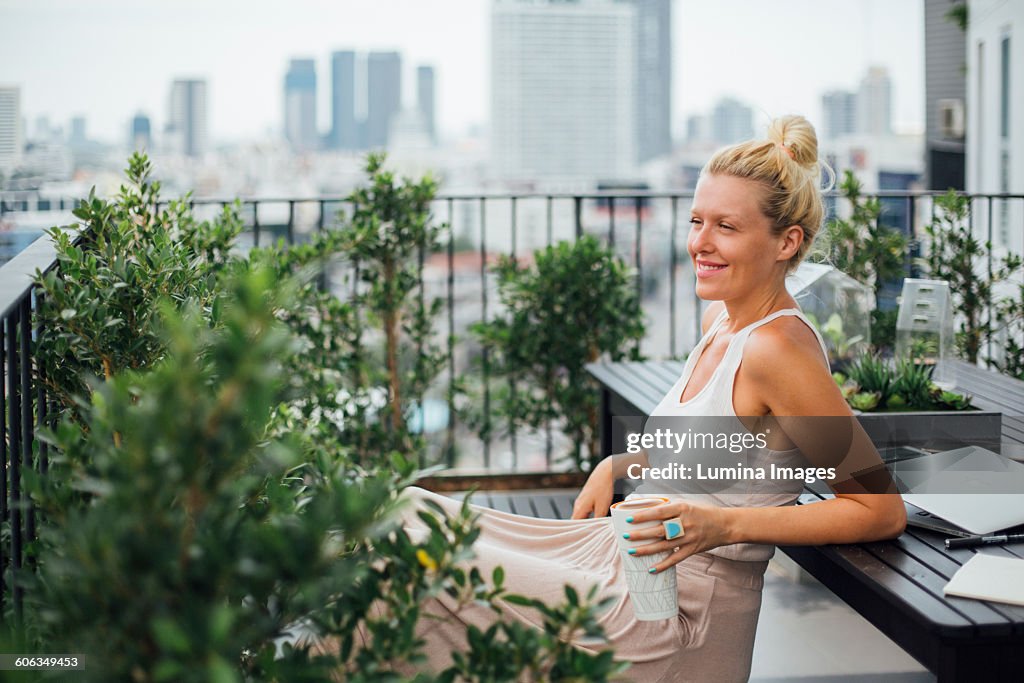 Caucasian woman sitting on balcony