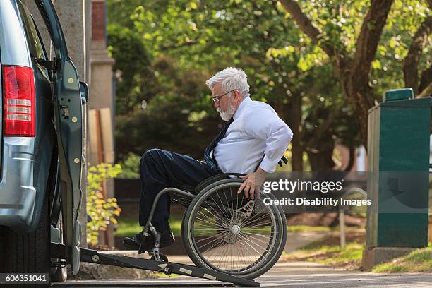 caucasian businessman in wheelchair entering van - wheelchair ramp stock pictures, royalty-free photos & images