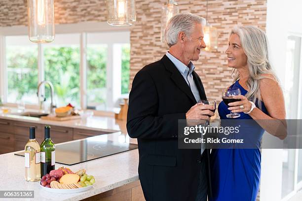 caucasian couple drinking wine in kitchen - pompano beach stock-fotos und bilder
