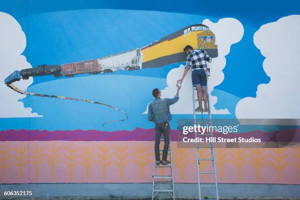 artists painting mural wall - elevated train stock pictures, royalty-free photos & images