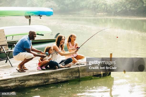 family fishing in lake - seattle pier stock pictures, royalty-free photos & images