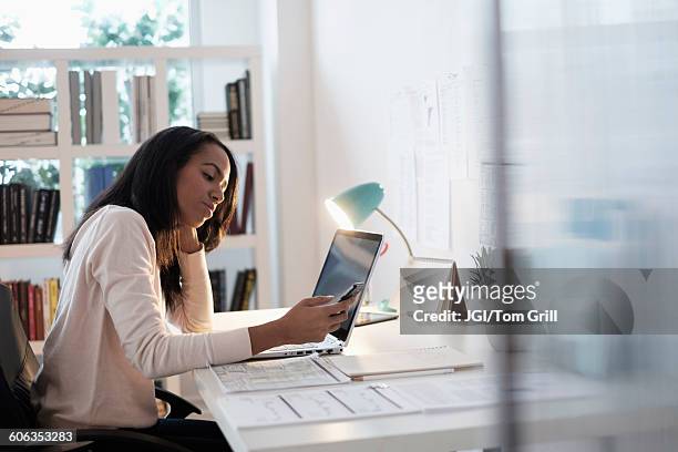mixed race businesswoman using cell phone - answering stock pictures, royalty-free photos & images