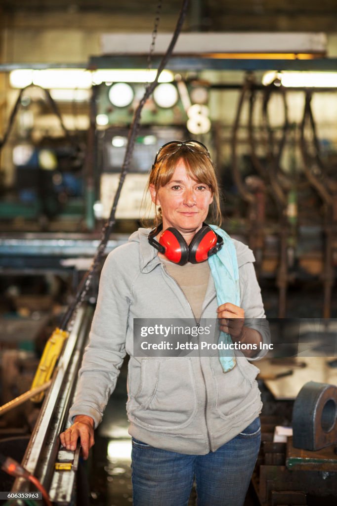 Caucasian worker smiling in factory