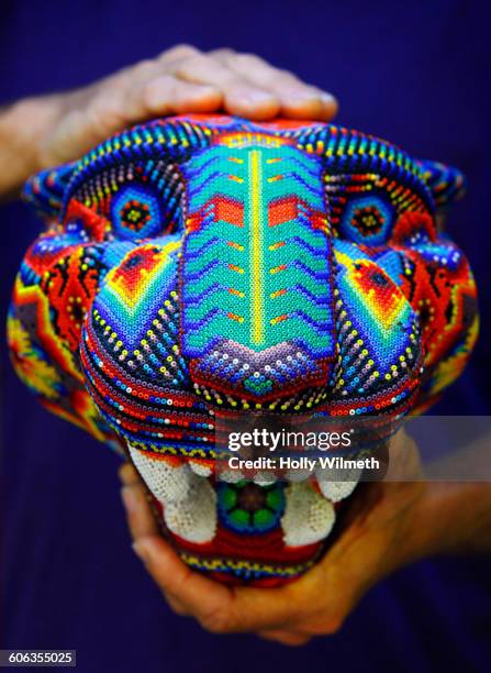 artisan holding traditional beaded sculpture - huichol fotografías e imágenes de stock