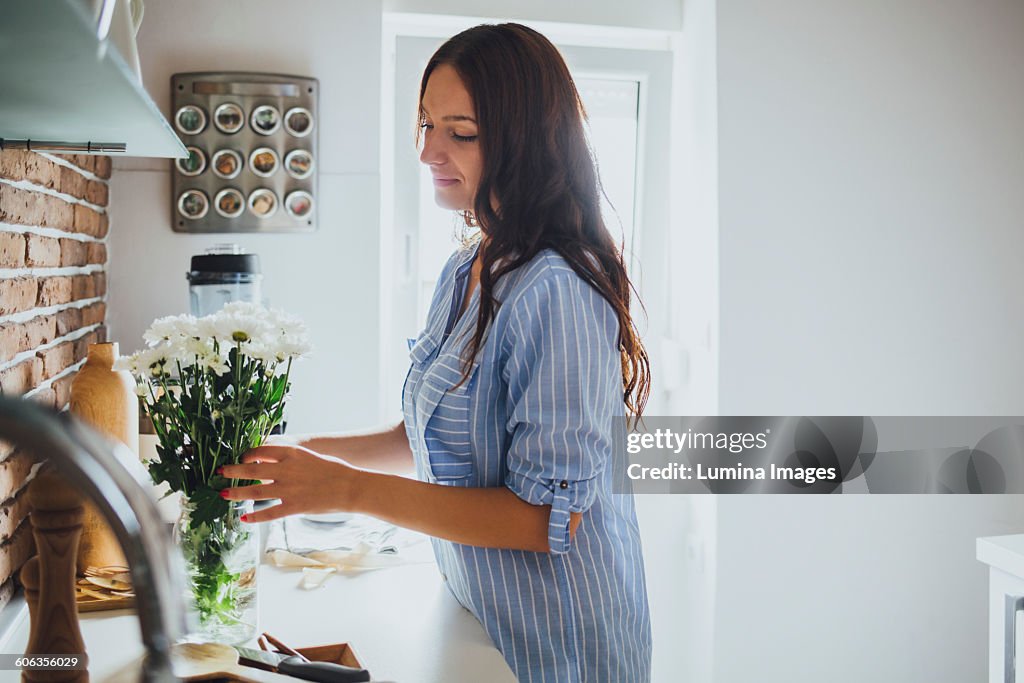 Caucasian woman arranging flowers