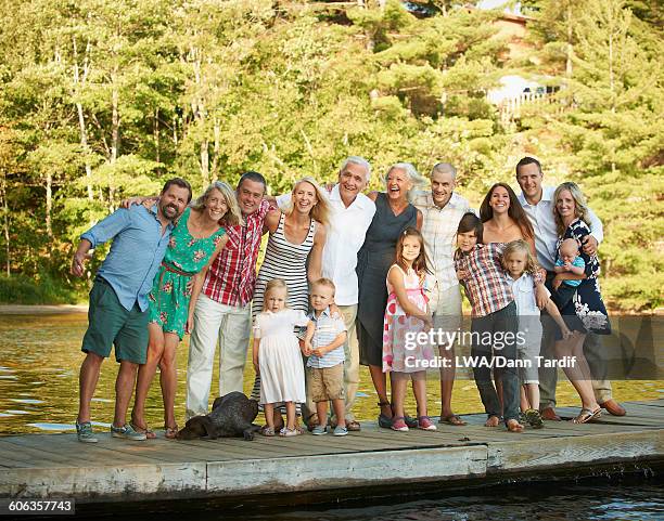 caucasian family smiling on pier - large family fotografías e imágenes de stock