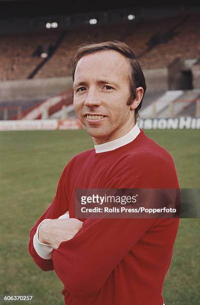 English footballer and midfielder with Manchester United Football Club, Nobby Stiles posed on the pitch at United's Old Trafford stadium in...