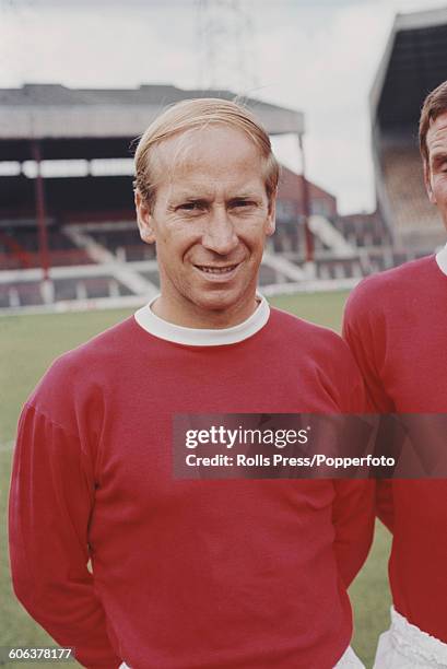 English footballer and midfielder with Manchester United Football Club, Bobby Charlton posed on the pitch at United's Old Trafford stadium in...