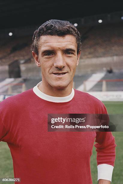 English footballer and centre-back with Manchester United Football Club, Bill Foulkes posed on the pitch at United's Old Trafford stadium in...