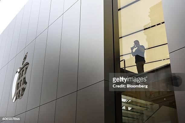 An employee photographs customers waiting in line for the release of the Apple Inc. IPhone 7 and 7 Plus an Apple Inc. In San Francisco, California,...
