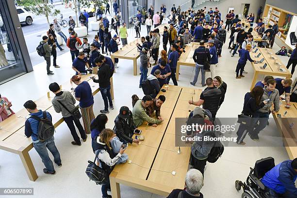Customers browse products during the release of the Apple Inc. IPhone 7 and 7 Plus smartphones at an Apple Inc. In San Francisco, California, U.S.,...