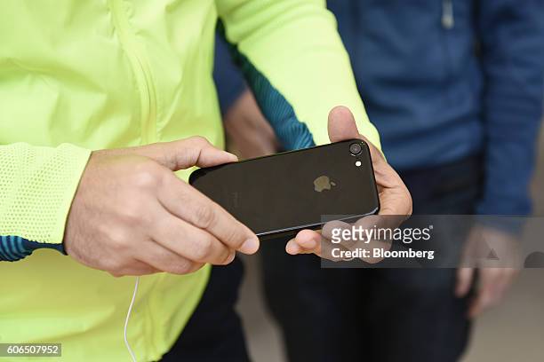 Customer views an iPhone 7 smartphone at an Apple Inc. In San Francisco, California, U.S., on Friday, Sept. 16, 2016. Shoppers looking to buy Apple...