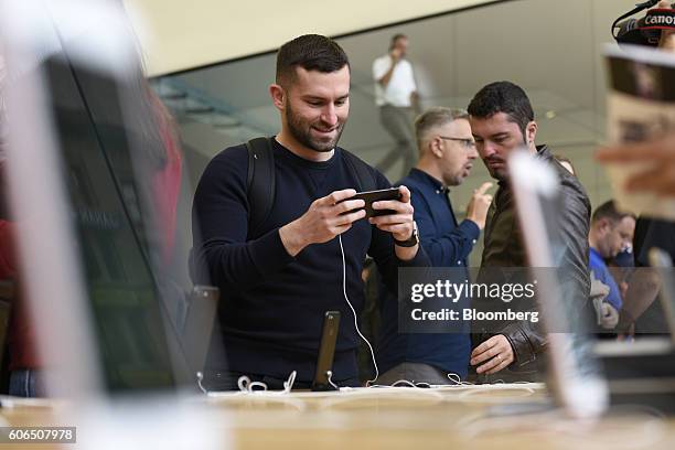 Customer views an iPhone 7 smartphone at an Apple Inc. In San Francisco, California, U.S., on Friday, Sept. 16, 2016. Shoppers looking to buy Apple...